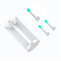 Clear cylindrical container with two silver ear studs and green ends on a white background