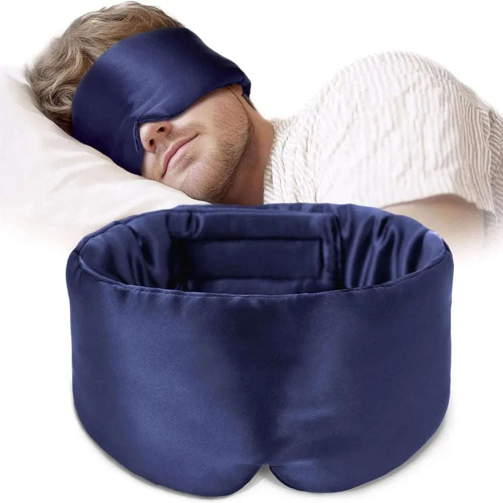 Man sleeping with a blue silk sleep mask and pillow on a white background