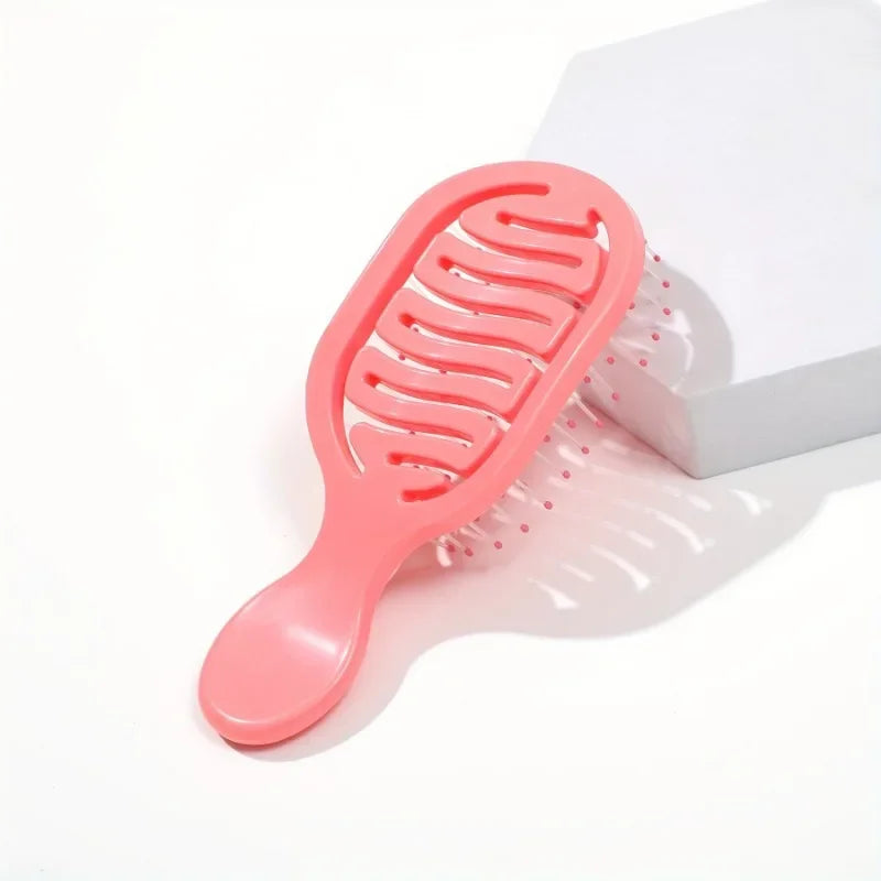Pink Mini Travel Hair Brush on a white background