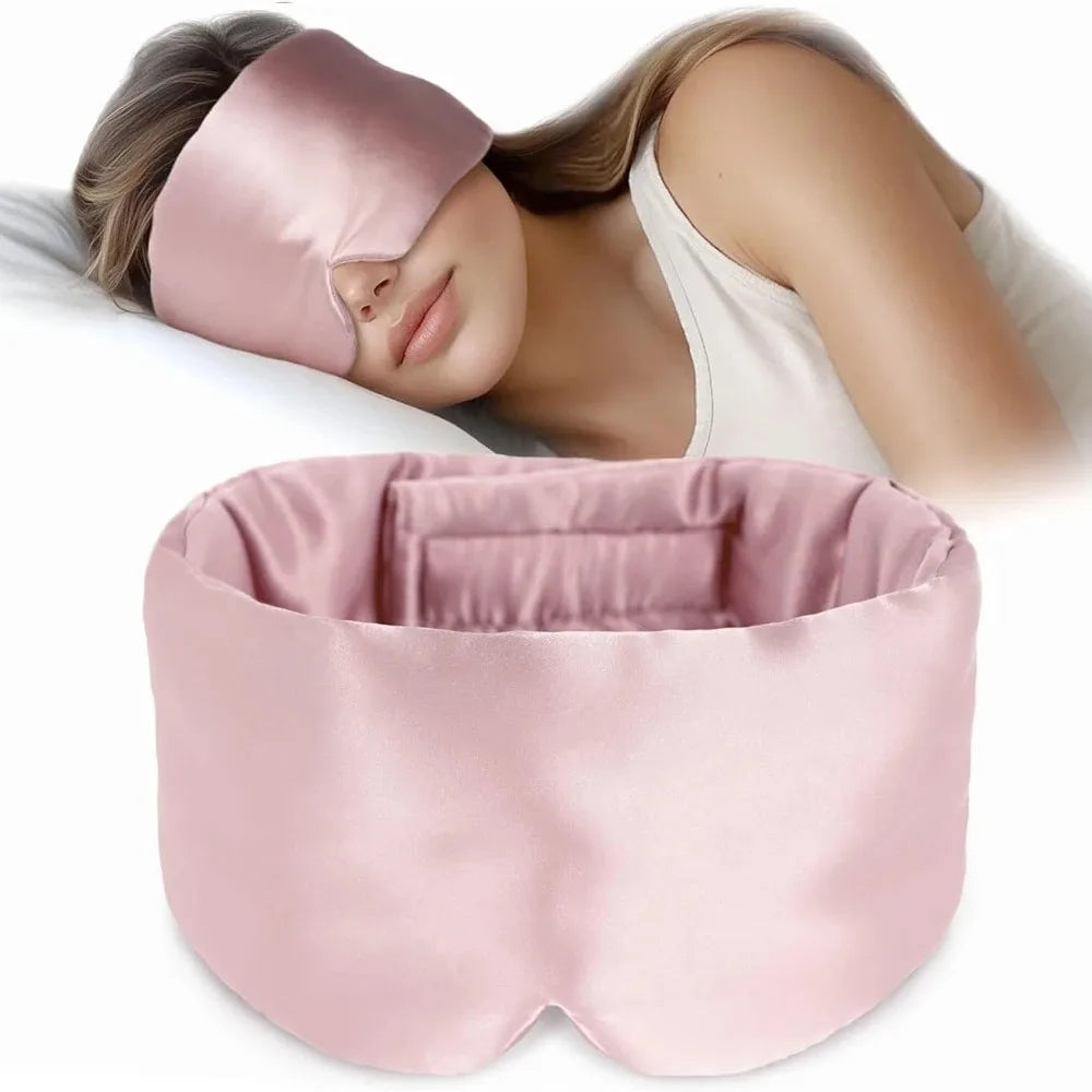 Pink mulberry silk eye mask worn by a person with a plain background