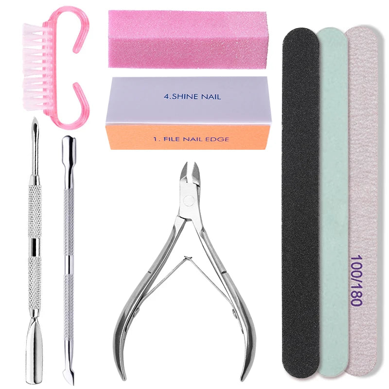 Set of nail care tools including files, brush, and cuticle nipper on a white background