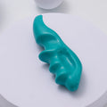 Turquoise Silicone shoulder massage tool object on a white background