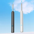 Two dental tools, one black and one white, against a blue sky background.
