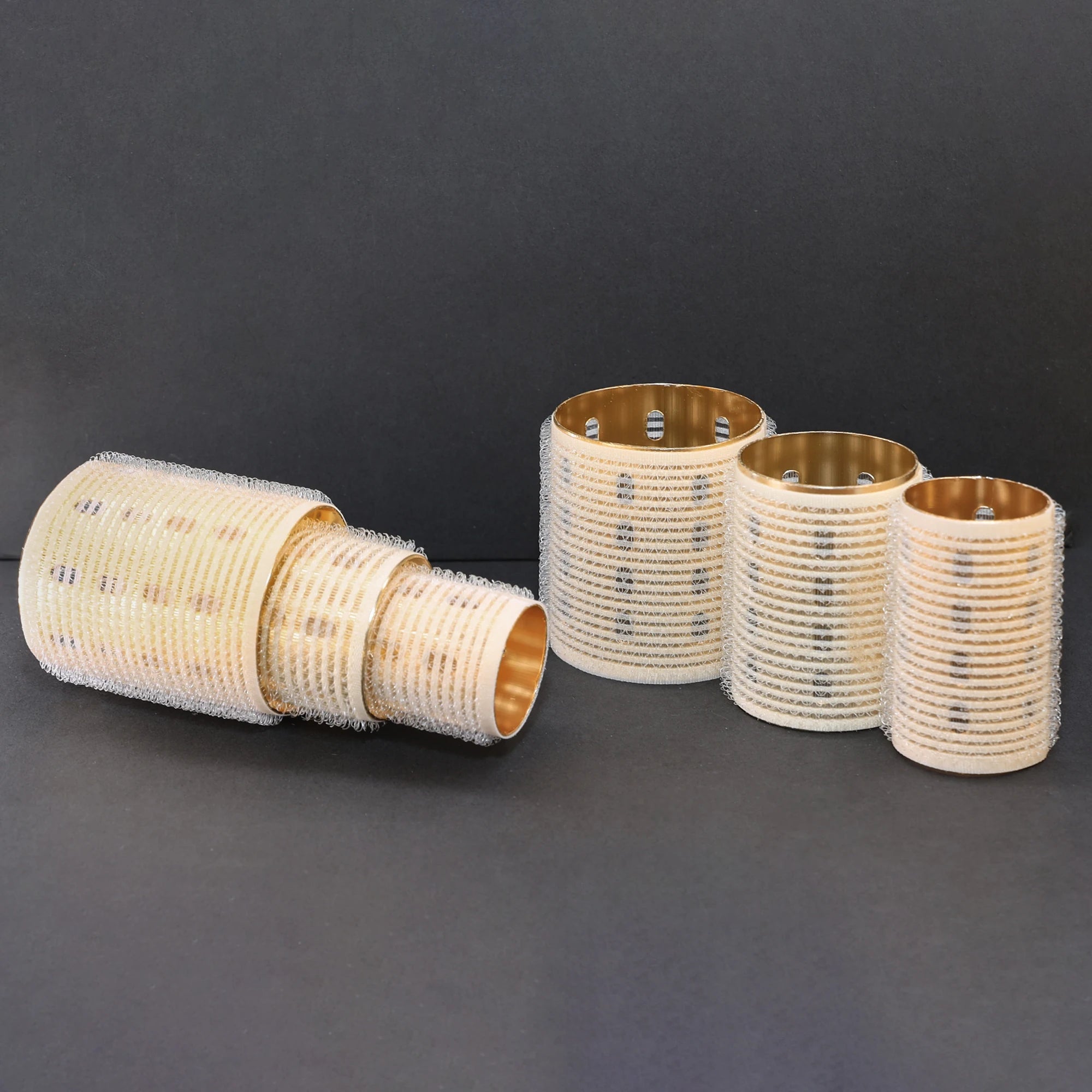 Set of ceramic thermal hair rollers on a dark background