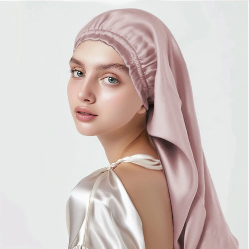 Woman wearing a pink pure mulberry silk bonnet headscarf on a white background