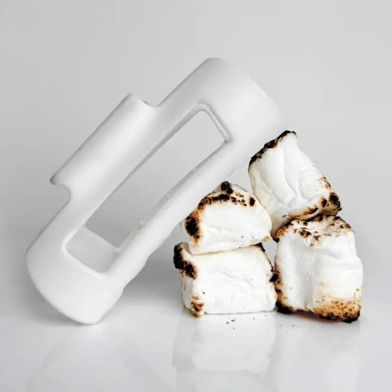 White soft claw clip with toasted marshmallows on a light gray background
