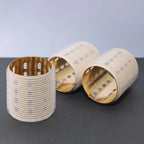 ceramic thermal hair rollers on dark grey and white background. 