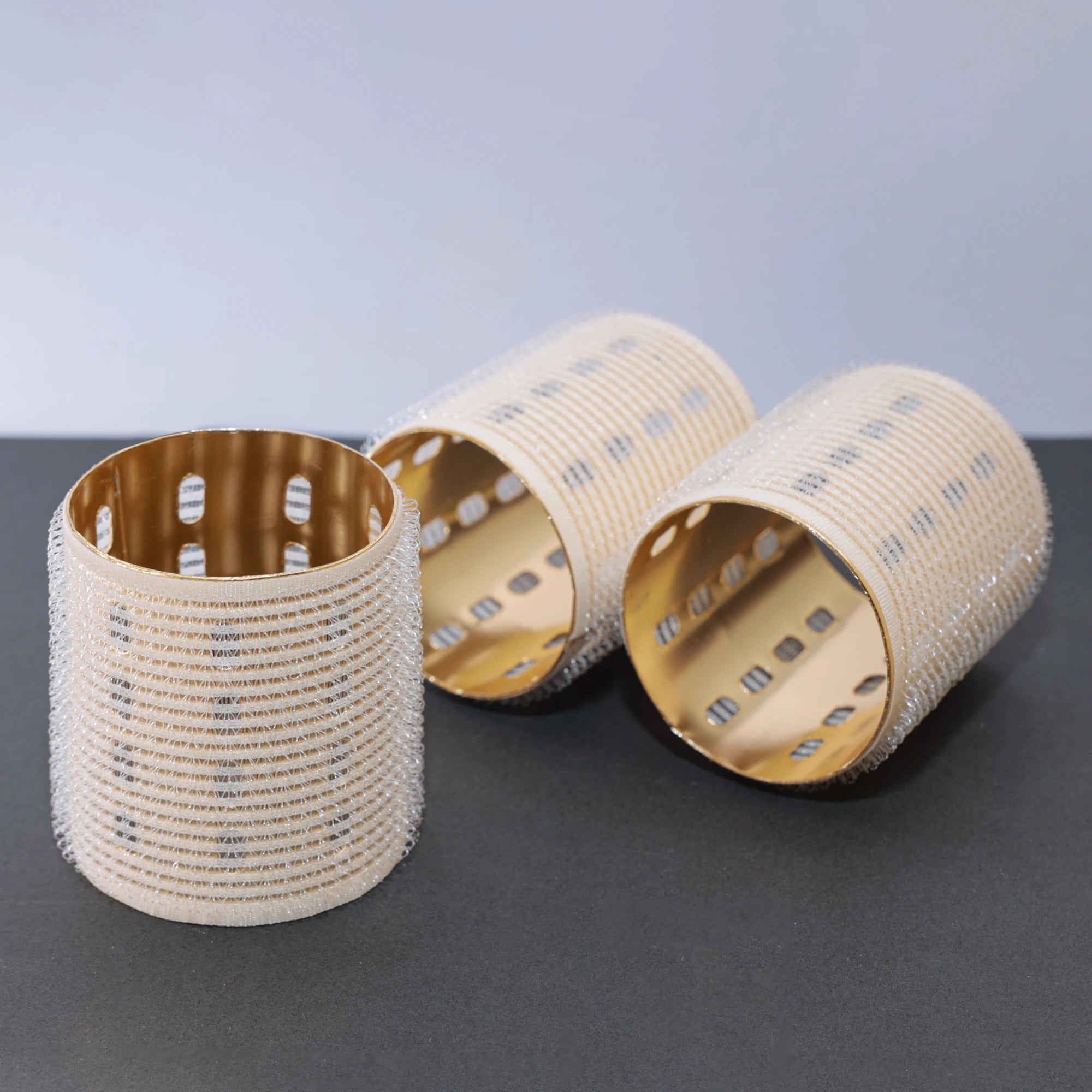 ceramic thermal hair rollers on dark grey and white background. 