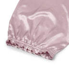 Pink pure mulberry silk bonnet headscarf bonnet on a white background, close up on elastic head fastening 