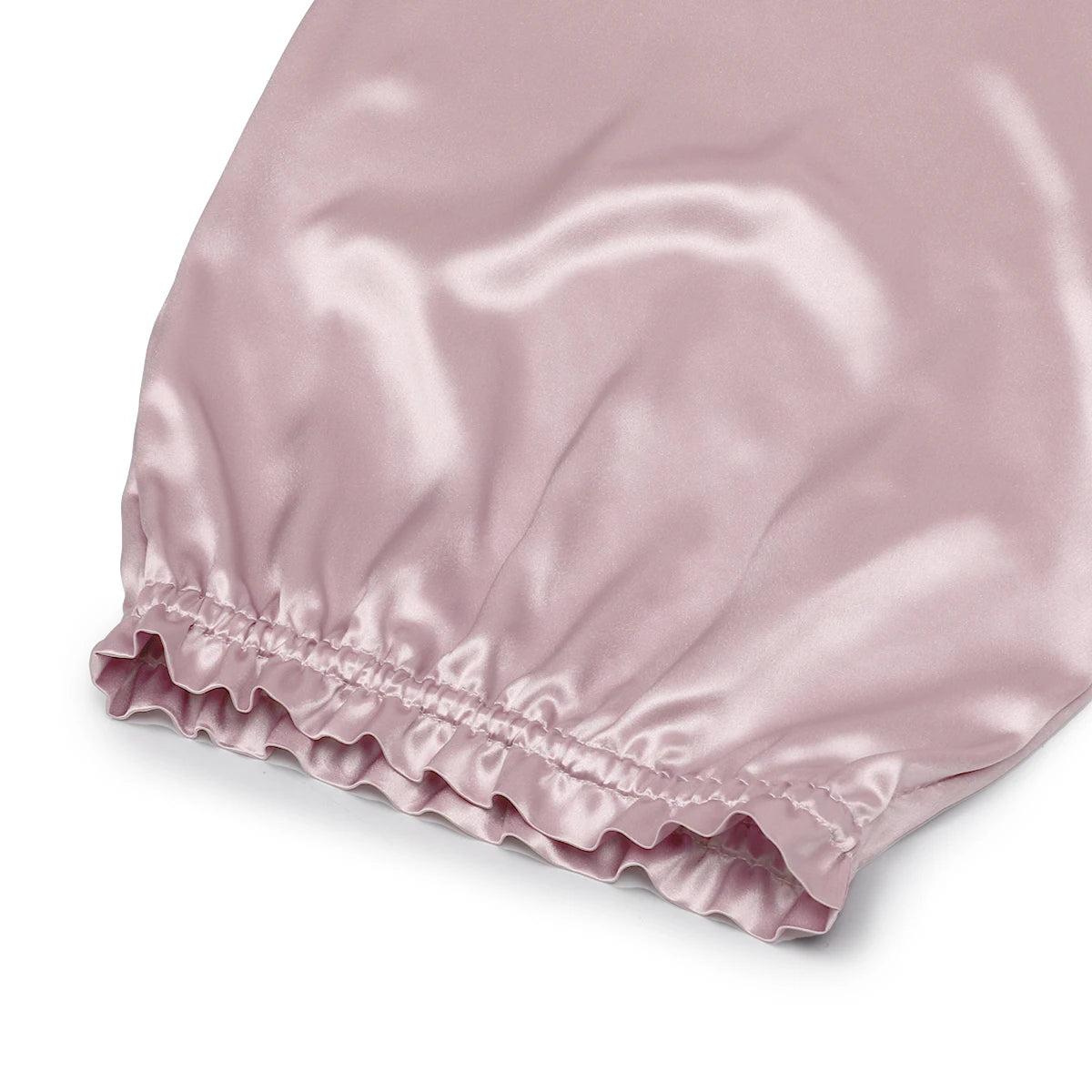 Pink pure mulberry silk bonnet headscarf bonnet on a white background, close up on elastic head fastening 